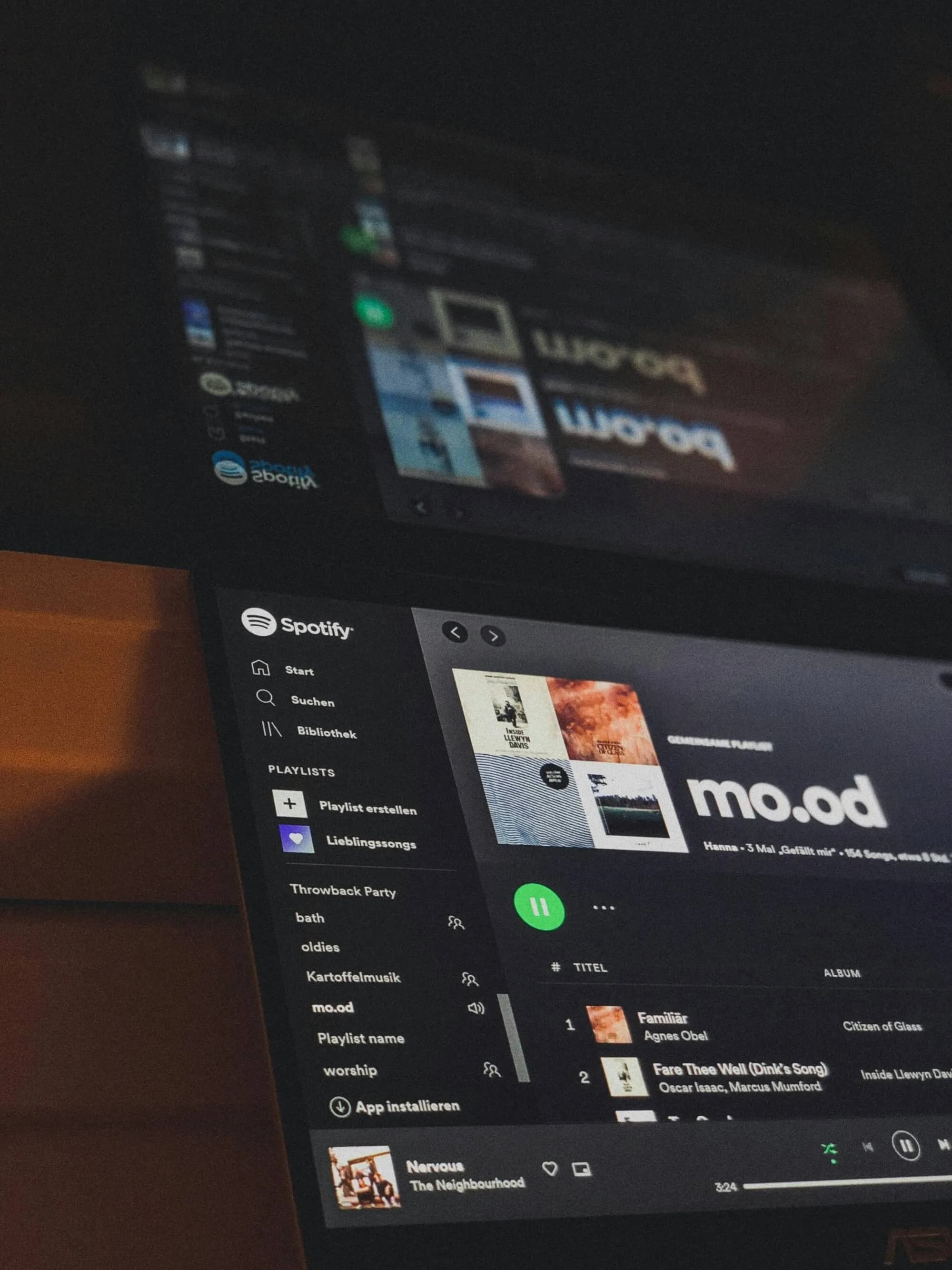 A shared Spotify playlist on a laptop at night